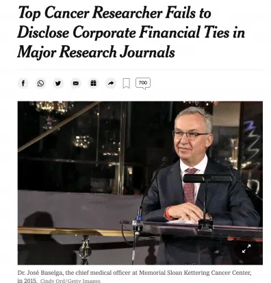 Man in suit speaking at podium with headline