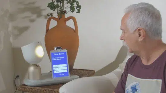 Person using tablet to control smart lamp