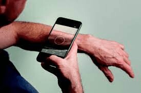 Person taking photo of wrist with smartphone