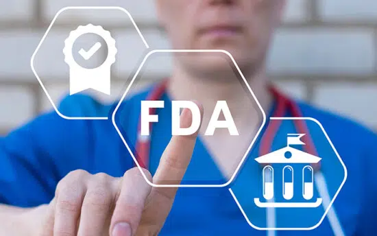 Medical professional pointing at FDA approval icons