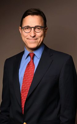 Smiling man in suit with red tie