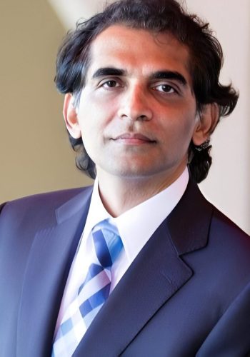 Business headshot of man in suit and tie